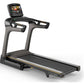 Matrix TF50 folding treadmill with black frame, gray accents, touchscreen display, and wide running belt on white background