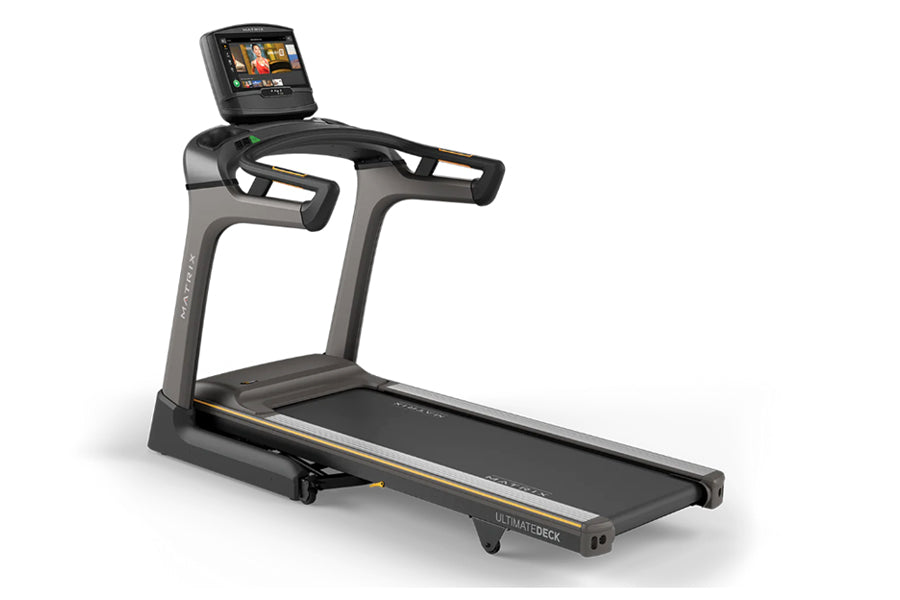 Matrix TF50 folding treadmill with black frame, gray accents, touchscreen display, and wide running belt on white background