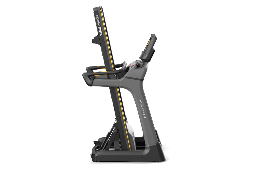 Matrix TF50 folding treadmill with dark gray frame, gold accent stripe, and adjustable console on white background