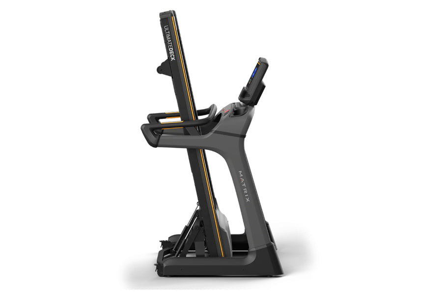 Matrix TF50 folding treadmill with black frame, gold accents, and digital console on white background