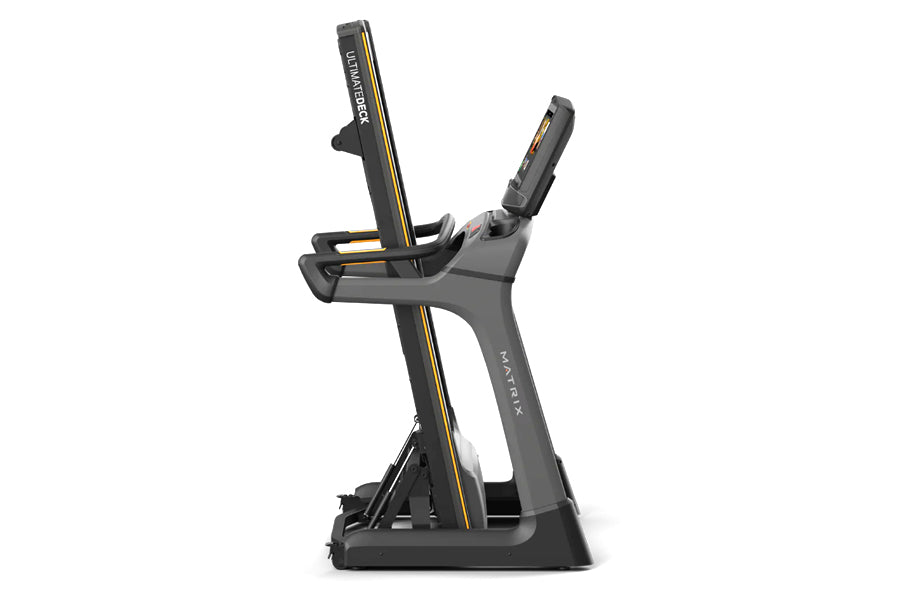 Matrix TF50 folding treadmill with gray frame, black base, and gold accents on white background