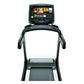 Matrix TF50 folding treadmill with black frame, touchscreen display showing workout content, and gray running deck on white b