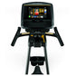 Matrix U30 upright exercise bike with black frame, gold accents, dual handles, and touchscreen display showing workout conten