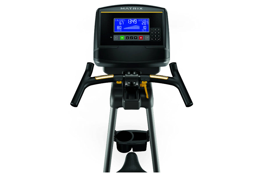 Matrix U30 upright exercise bike with black frame, dual handles, blue LCD display console showing metrics, and pedals with fo
