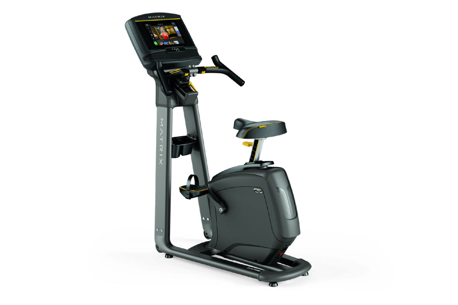 Black and gray upright exercise bike with digital display screen, handlebar, seat, and foot pedals on white background