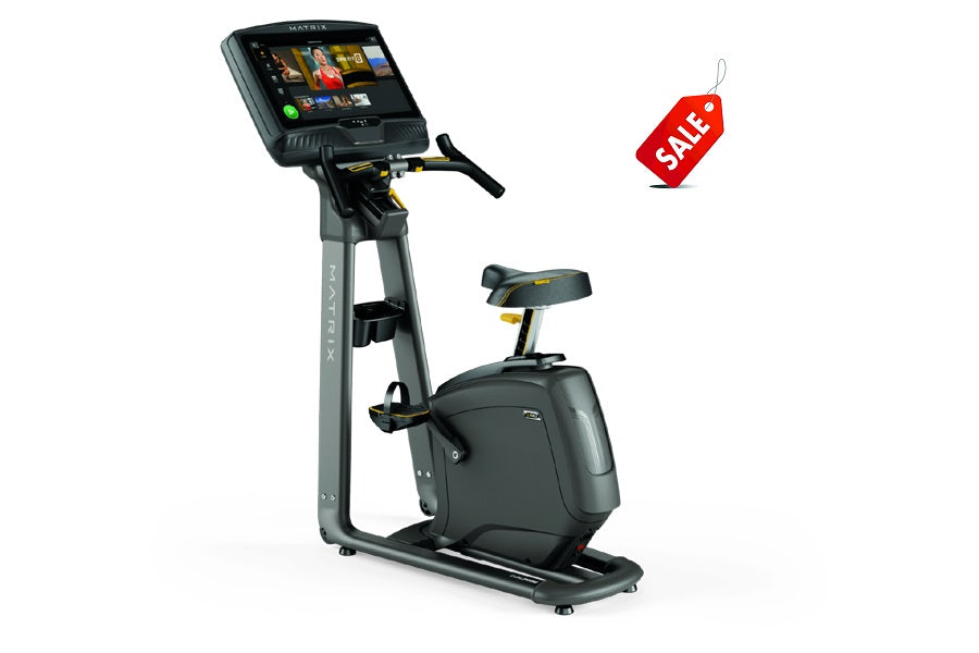 Matrix U50 upright exercise bike with black and gray frame, digital touchscreen console, and red sale tag on white background
