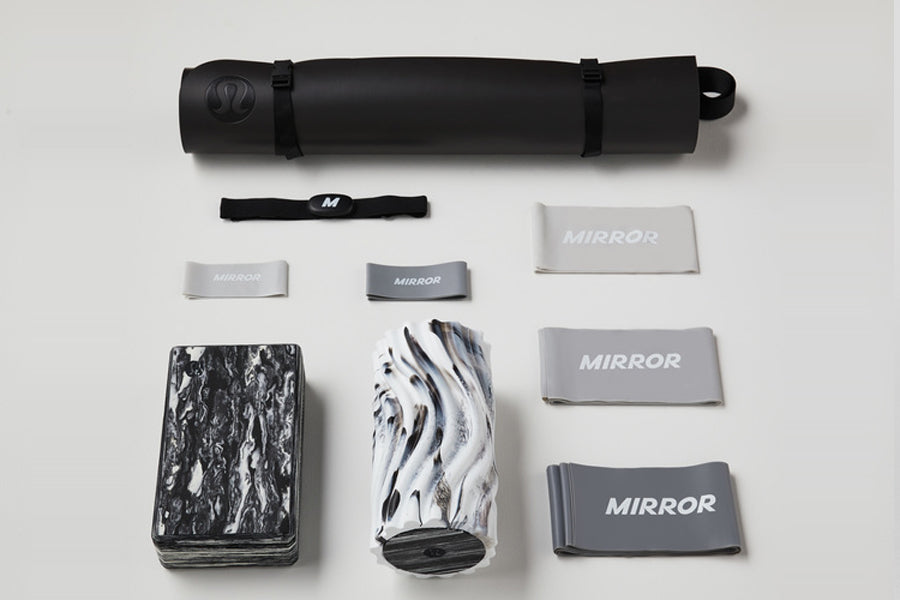Lululemon Studio Mirror Plus set with black carrying case, interchangeable mirror lenses in silver and patterned designs, bla