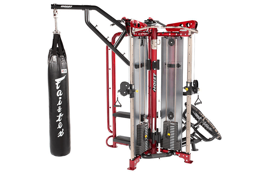 Hoist MCS-8004 Motioncage Studio Package 4 multi-station gym system in red and black with attached heavy bag on white backgro