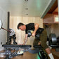 Man performing dumbbell curl with matte black adjustable weight in home gym setting