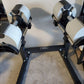 NÜOBELL 80lb adjustable dumbbells with white and black design on black stand, flat lay view