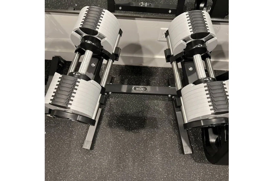 NÜOBELL 80lb adjustable dumbbells with white and gray plates, chrome handles, on black base, overhead view