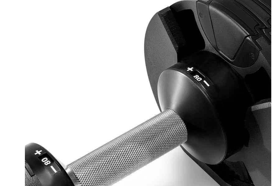 Pair of black and silver adjustable dumbbells with textured grip handles, displaying 80lb weight markers on white background
