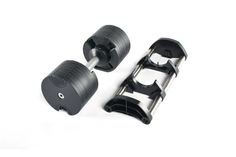 Pair of black adjustable dumbbells with chrome handles and matching black stand, flat lay on white background
