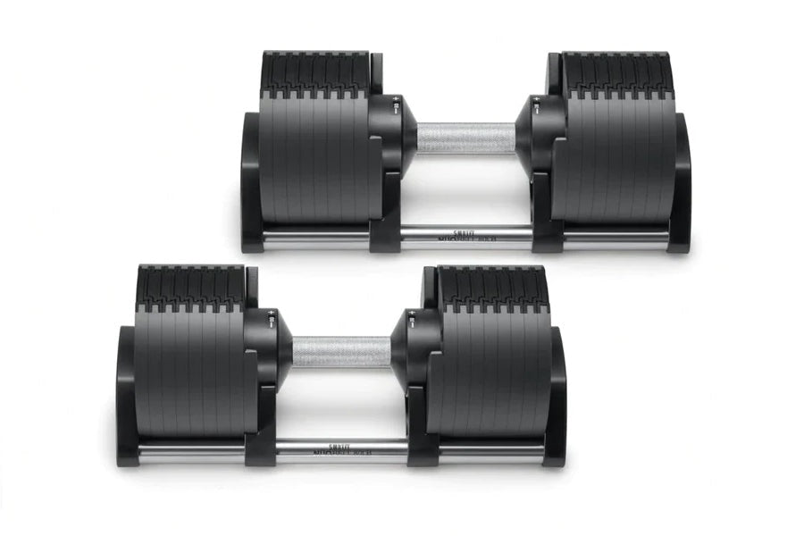 Pair of black adjustable dumbbells with ribbed rubber weight plates and silver metal handles, shown on white background