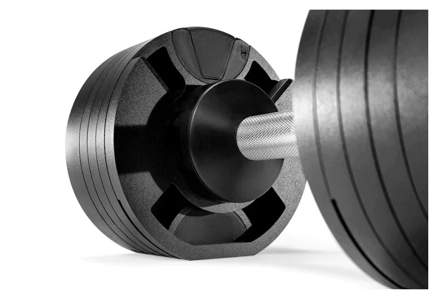 Black adjustable dumbbell with textured handle and weight plates on white background