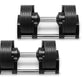 Pair of NÜOBELL adjustable dumbbells with black rubber-coated weight plates and silver metal handles on white background