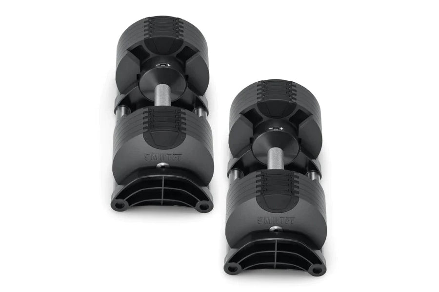 Pair of black NÜOBELL adjustable dumbbells with textured grip surfaces and metal handles on white background