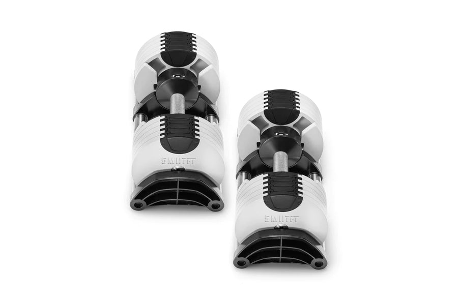 Pair of Nüobell 50lb adjustable dumbbells with white and black design on white background, flat lay view