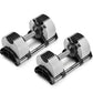 Pair of NÜOBELL adjustable dumbbells with white and black weight plates, chrome handles, and black base stands on white backg