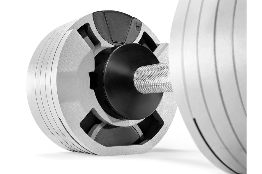 Ash gray adjustable dumbbell with black center dial and white textured handle, shown at angle on white background