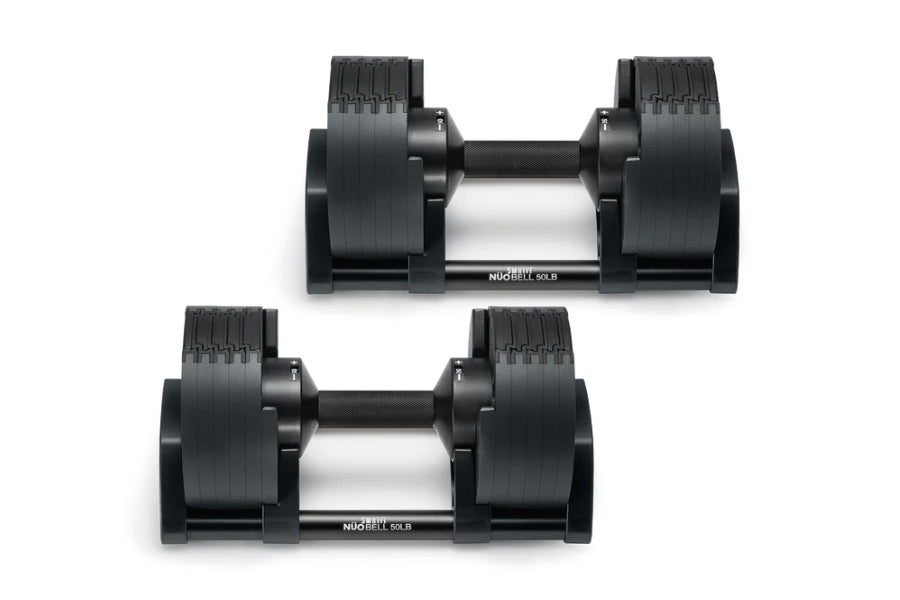 Pair of black adjustable dumbbells with textured grip handles and silver center bars, shown from side view on white backgroun