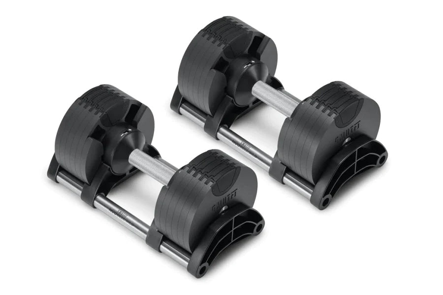 Pair of black adjustable dumbbells with chrome handles and numbered weight plates, flat lay on white background
