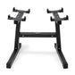 Black adjustable dumbbell stand with double legs, two horizontal arms with multiple clamps, and rubberized feet on white back
