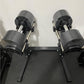 Pair of gray and black adjustable dumbbells on black NUO double-legged stand, flat lay view