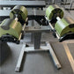 NÜOBELL adjustable dumbbell stand with neon yellow and black weights on gray floor, single-leg steel frame design
