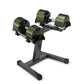 Pair of olive green and black adjustable dumbbells on single-legged steel stand, displayed on white background