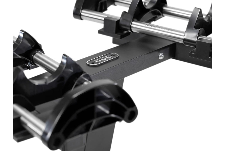 NÜOBELL adjustable dumbbell stand with single black leg, chrome bars, and curved grip handles on white background