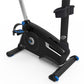 Black upright exercise bike with blue accents, adjustable seat, handlebars, and foot pedals on white background