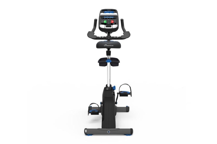 Black upright exercise bike with blue accents, digital console display, curved handlebars, and foot pedals, shown on white ba