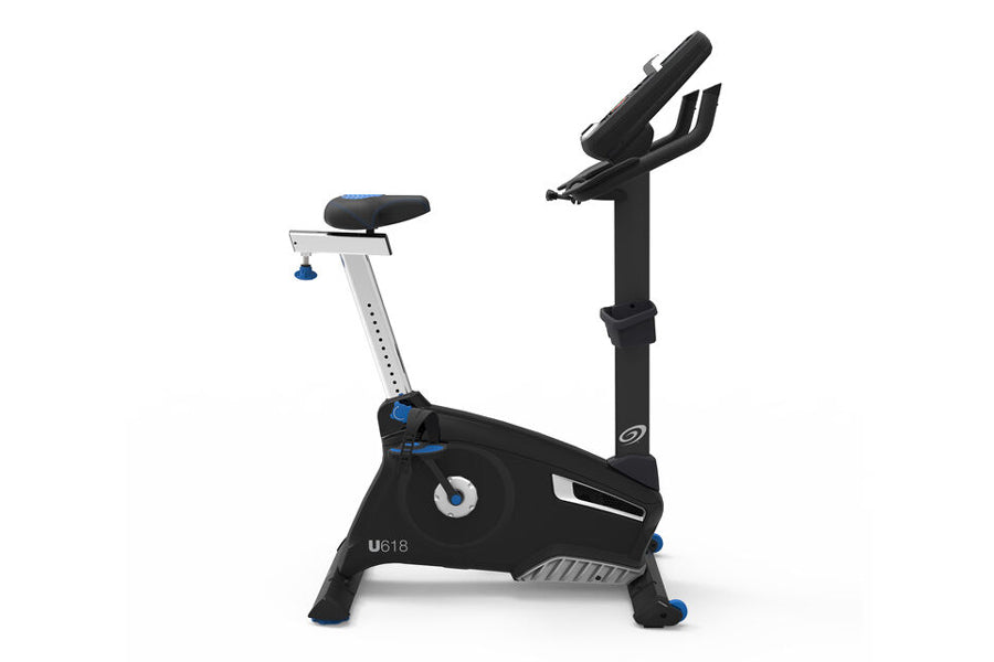 Nautilus U618 upright exercise bike with black frame, blue accents, adjustable seat, and digital display on white background