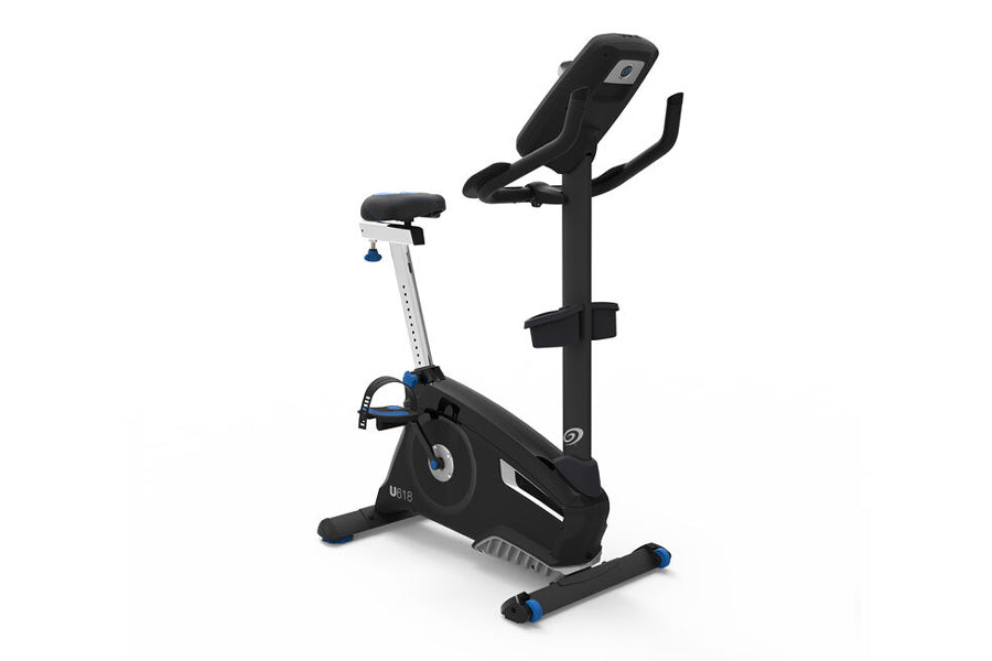 Nautilus U618 upright exercise bike with black frame, white vertical post, blue accents, and padded black seat on white backg