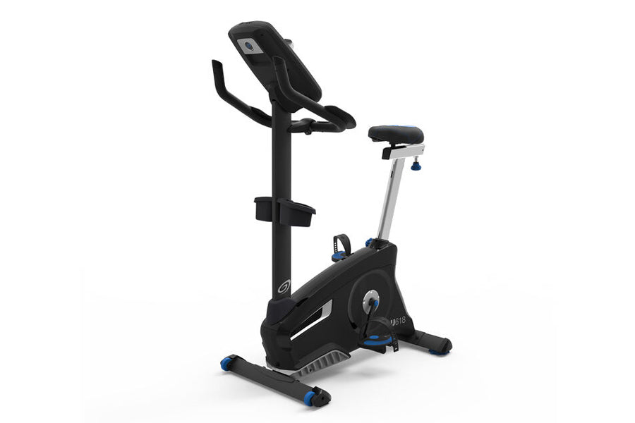 Black and silver upright exercise bike with blue accents, padded seat, handlebar display, and footrest on white background
