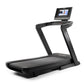 Black NordicTrack 1750 commercial treadmill with wide running deck, curved handrails, and digital touchscreen display on whit