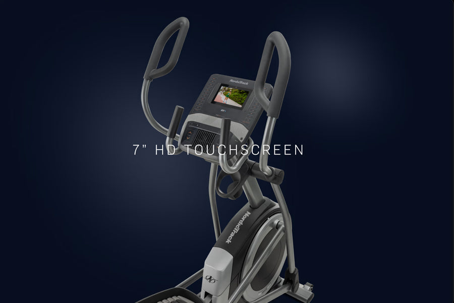 NordicTrack commercial elliptical machine with 7-inch HD touchscreen, dual handle arms, and gray frame on dark background