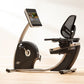 NordicTrack Commercial R35 black and tan recumbent exercise bike with tablet holder, shown on wooden floor in home setting