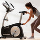 Woman using black and silver NordicTrack VU 29 upright exercise bike in home gym setting
