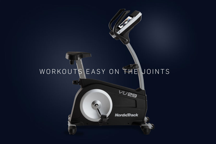 NordicTrack VU 29 upright exercise bike with black frame, silver accents, and digital console on dark background