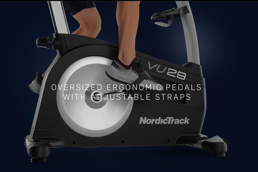 NordicTrack Commercial VU 29 upright exercise bike with black frame, white pedal wheel, and oversized ergonomic pedals with a