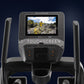NordicTrack FS10i elliptical with 10-inch touchscreen displaying landscape scenery, gray frame with black console and control