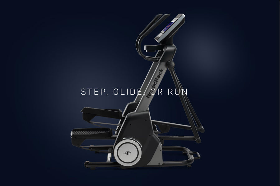 Black and gray elliptical machine with dual-motion arms, digital display console, and foot pedals on dark blue background