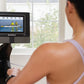Woman in lavender sports bra using NordicTrack rowing machine with display screen showing rowing workout video
