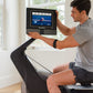 Man using NordicTrack RW700 rowing machine with digital display showing workout metrics in bright home setting