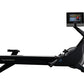 Black NordicTrack RW700 rowing machine with articulating touchscreen display showing workout video, flat lay on white backgro