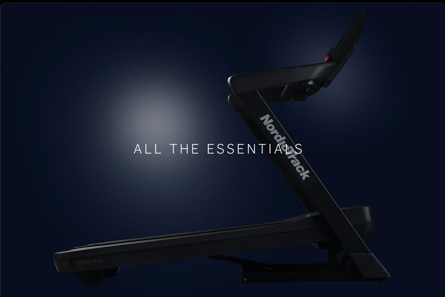 Black NordicTrack EXP 14i treadmill with angled running deck on dark blue background