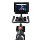 NordicTrack S15i stationary exercise bike with black frame, curved gray handlebars, orange console button, and touchscreen di