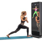 Woman performing lunge exercise on blue mat facing black interactive fitness mirror displaying workout instructor and form gu